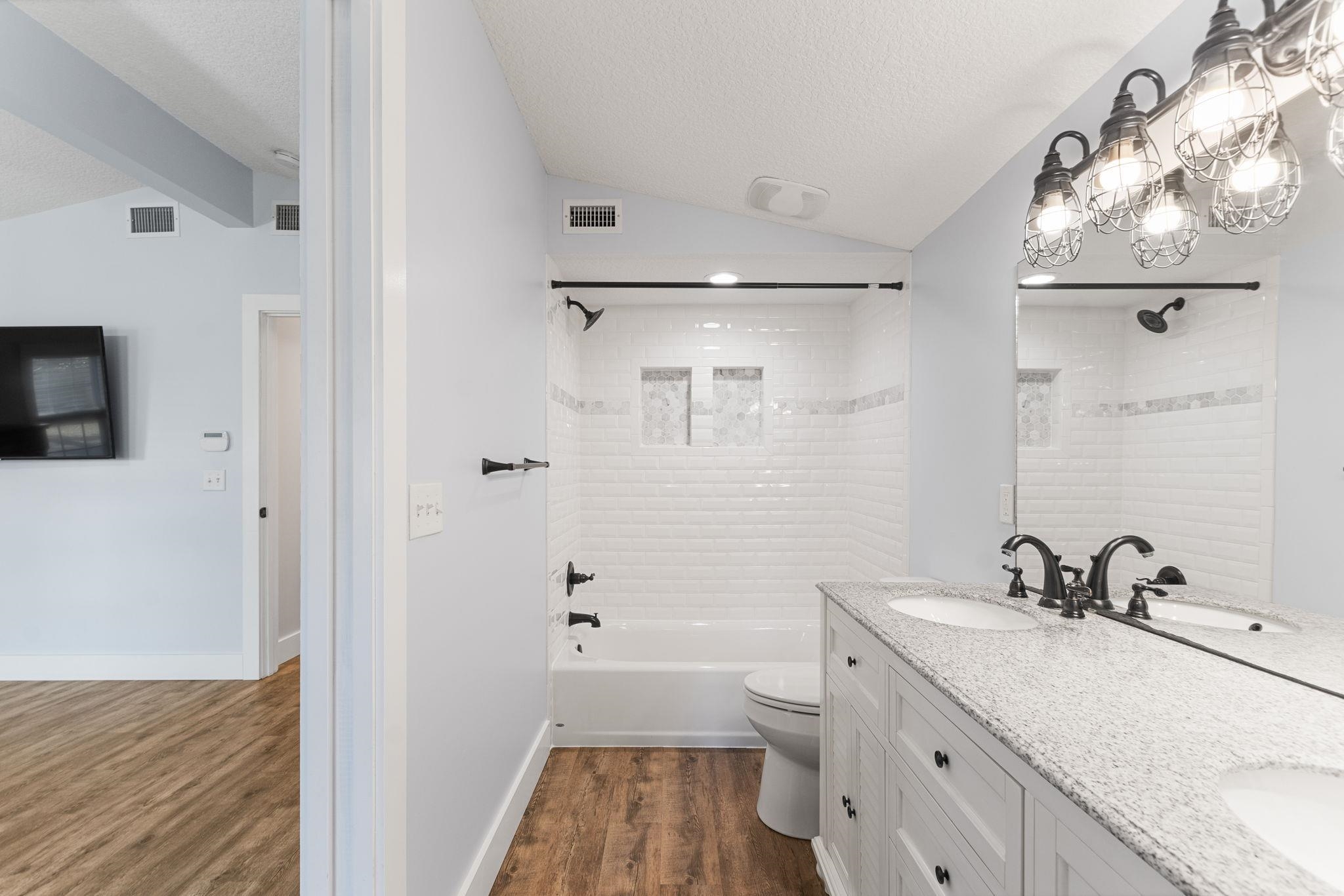 1385 Highland Boulevard St. Augustine, FL 32084 - Photo 23 of 47 a bathroom with a sink a toilet and shower