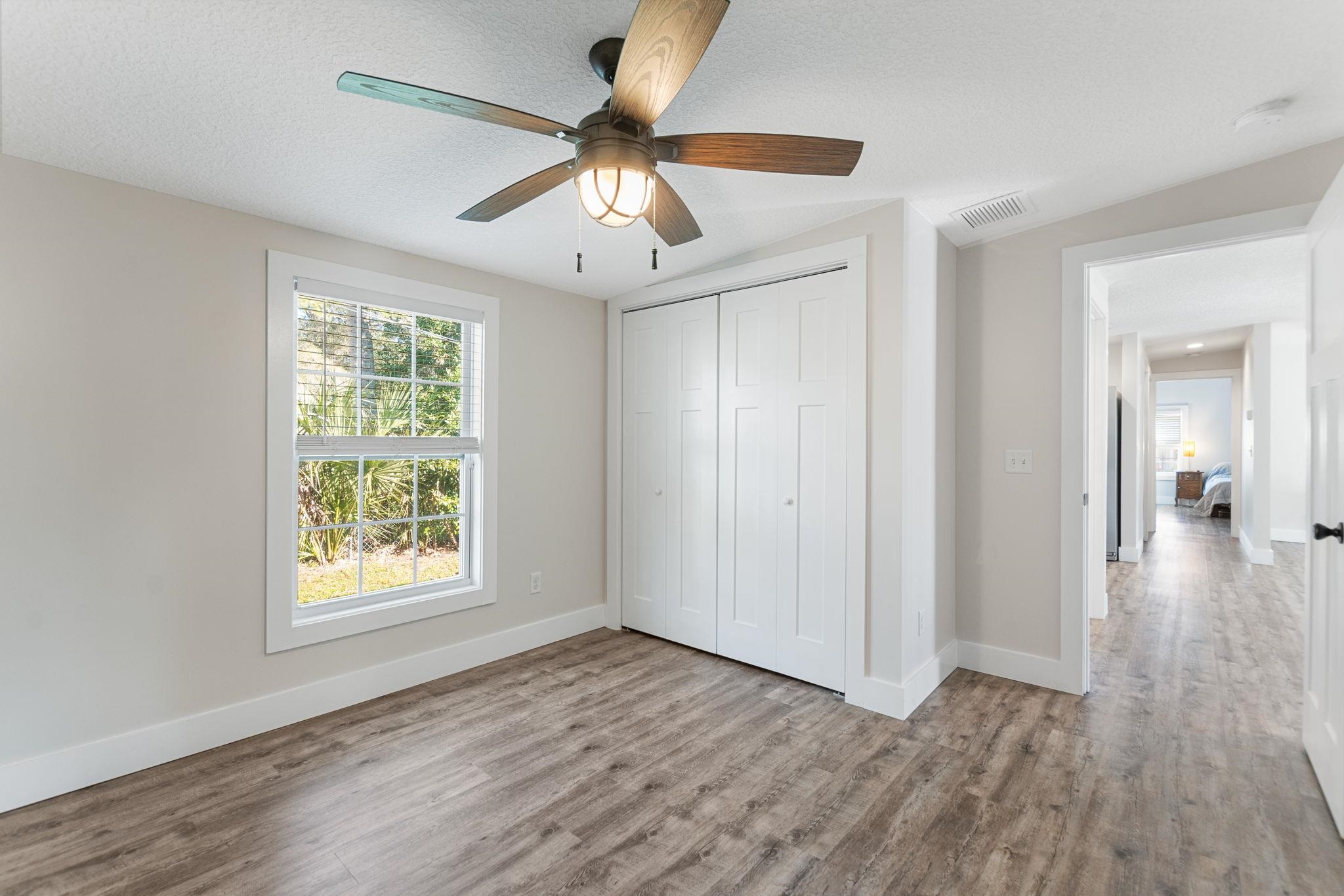 1385 Highland Boulevard St. Augustine, FL 32084 - Photo 31 of 47 a view of an empty room with wooden floor and a window
