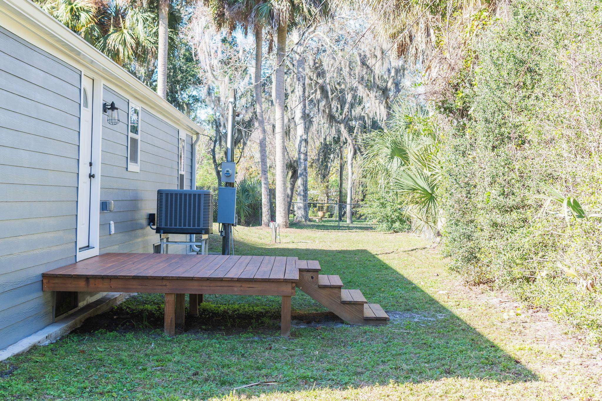 1385 Highland Boulevard St. Augustine, FL 32084 - Photo 34 of 47 a backyard of a house with table and chairs