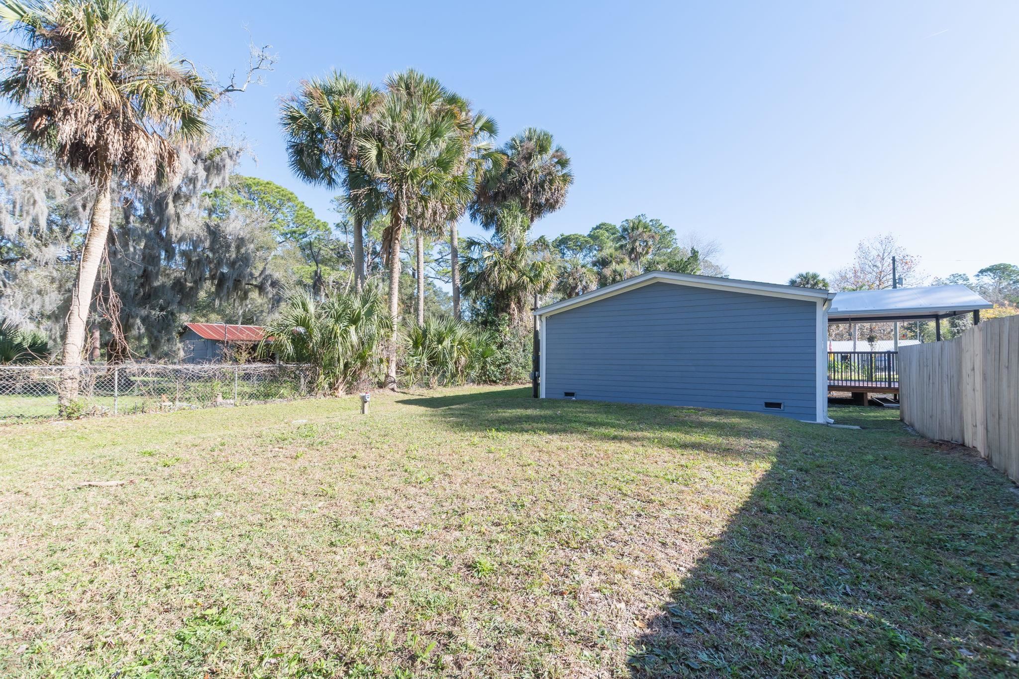 1385 Highland Boulevard St. Augustine, FL 32084 - Photo 42 of 47 a house with trees in front of it
