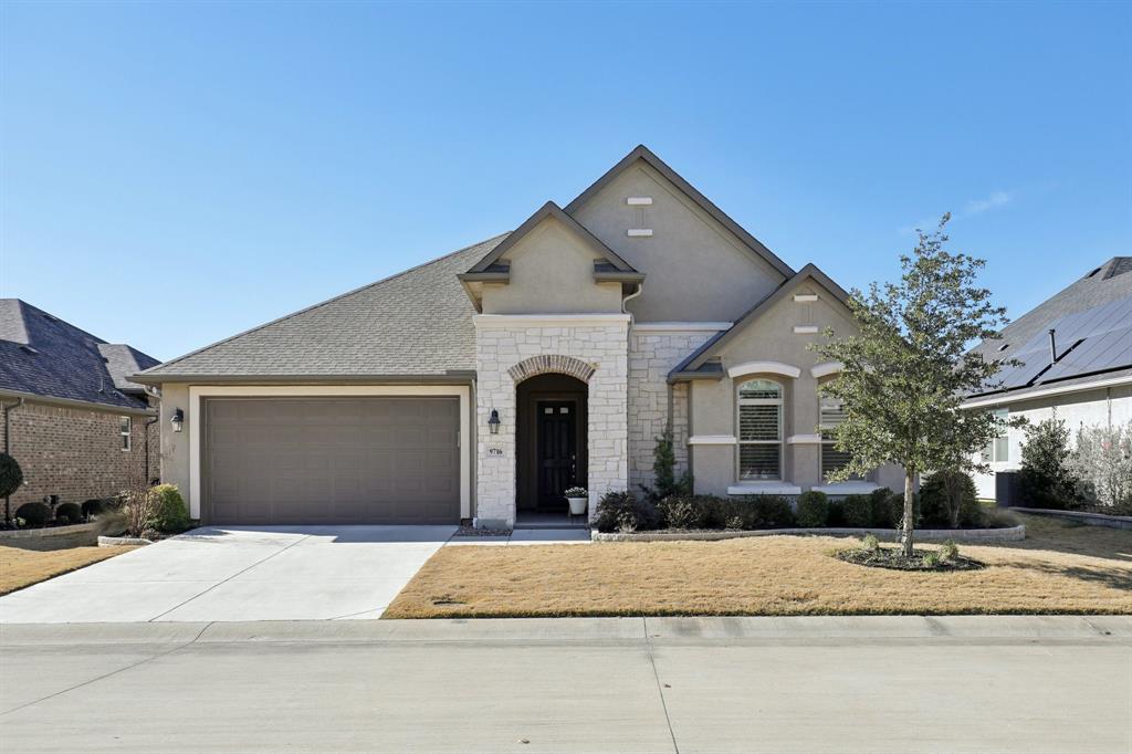 a front view of a house with a yard and a garage