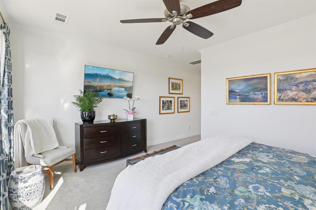 9716 Silver Rock Way Denton, TX 76207 - Photo 13 of 25 a bedroom with a bed and a painting on the wall