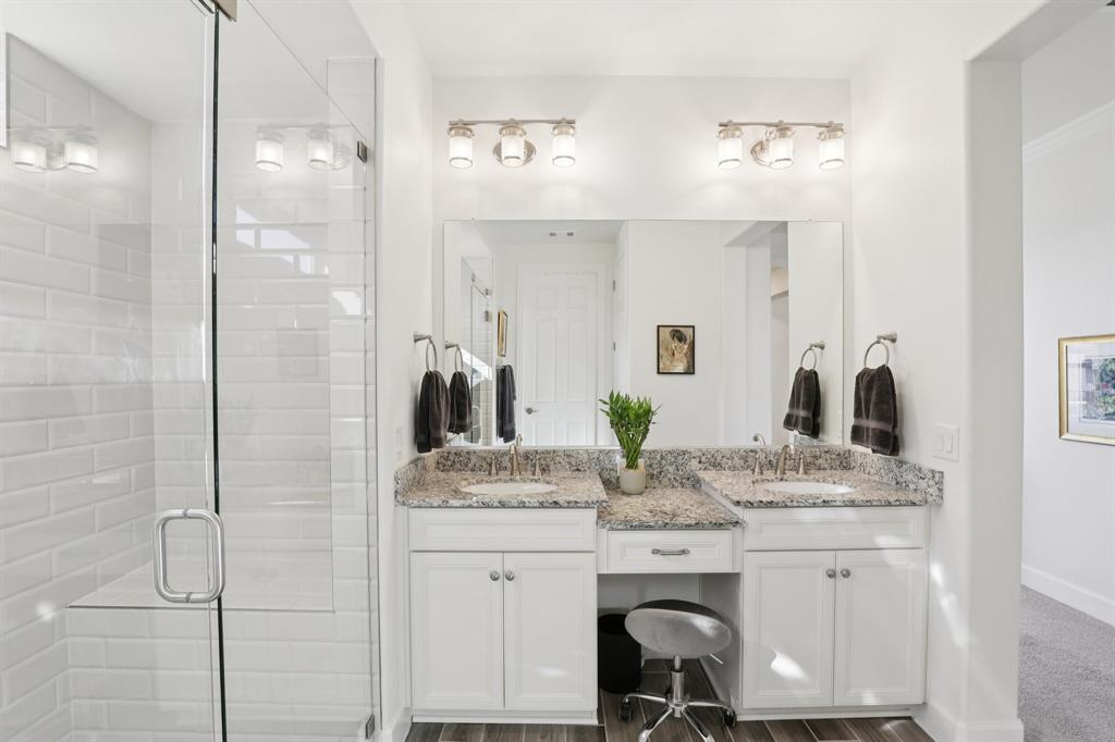 9716 Silver Rock Way Denton, TX 76207 - Photo 14 of 25 a en suite bathroom with a granite countertop sink a mirror and shower