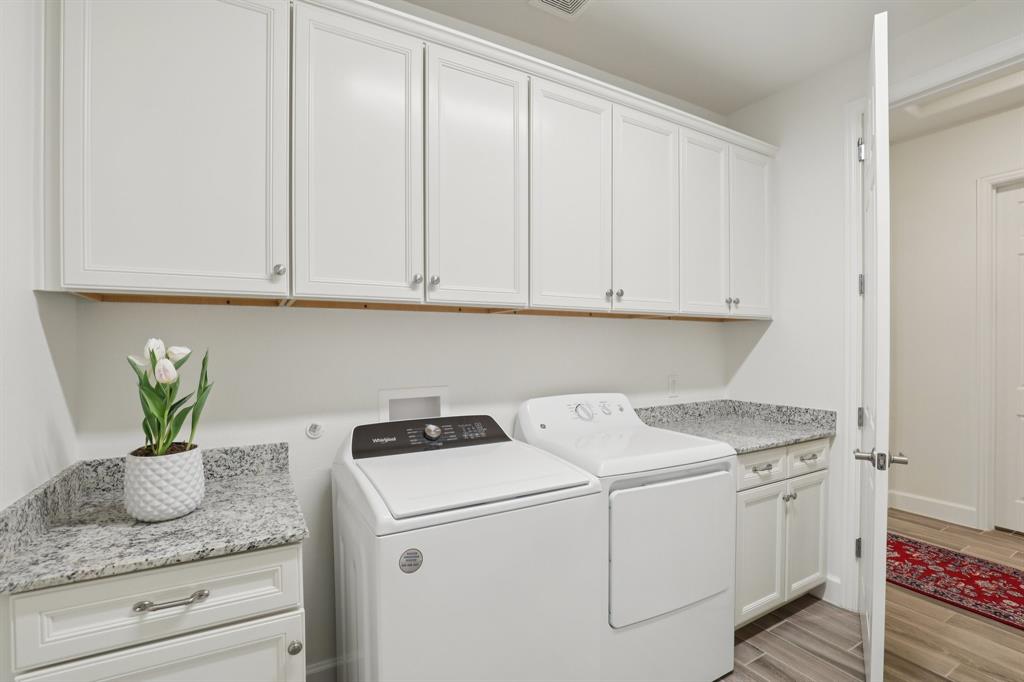 9716 Silver Rock Way Denton, TX 76207 - Photo 19 of 25 a view of cabinets with washer and dryer