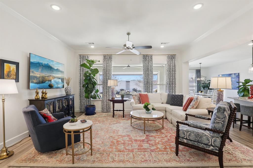 9716 Silver Rock Way Denton, TX 76207 - Photo 2 of 25 a living room with furniture and a chandelier