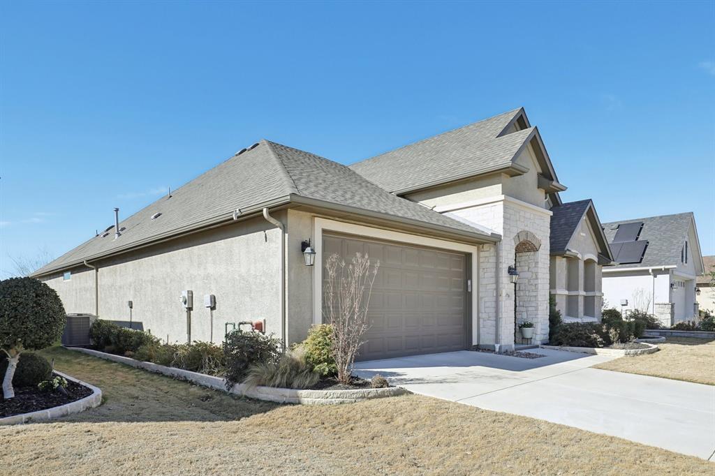 9716 Silver Rock Way Denton, TX 76207 - Photo 24 of 25 a front view of a house with garden