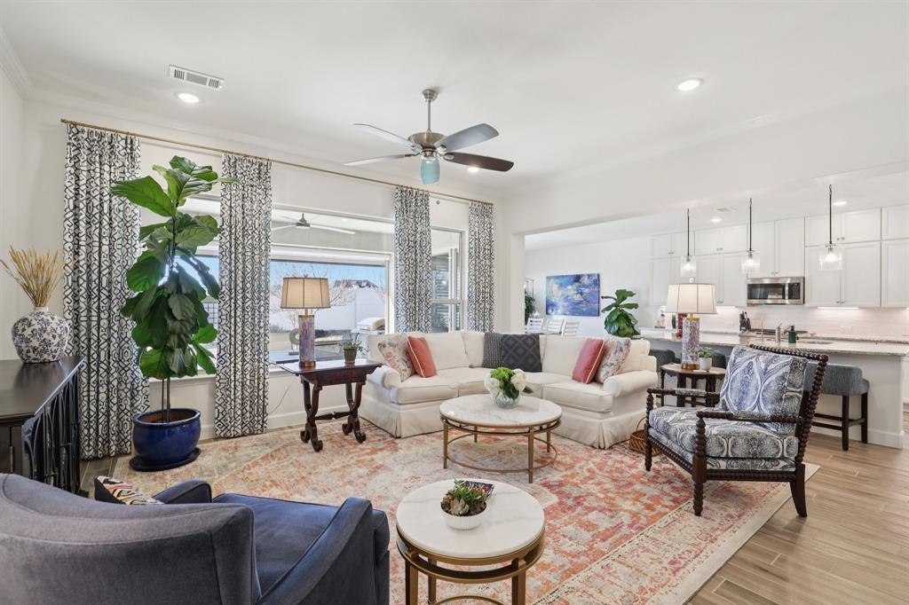 9716 Silver Rock Way Denton, TX 76207 - Photo 3 of 25 a living room with furniture and a wooden floor