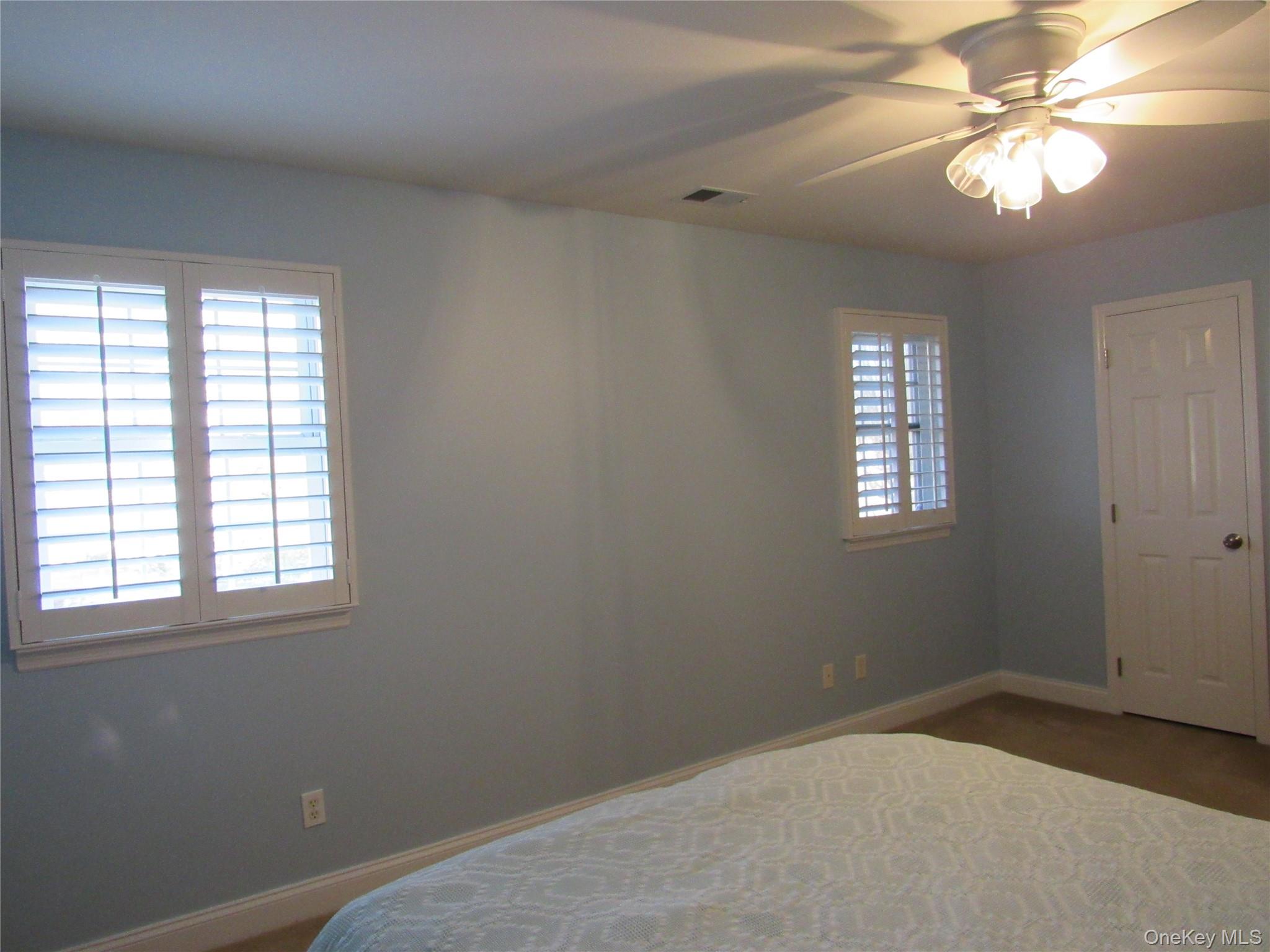 50 Strawberry Commons Riverhead, NY 11901 - Photo 23 of 33 an empty room with windows and fan