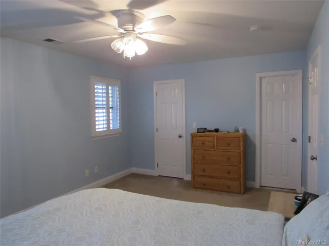a view of room with window and a ceiling fan