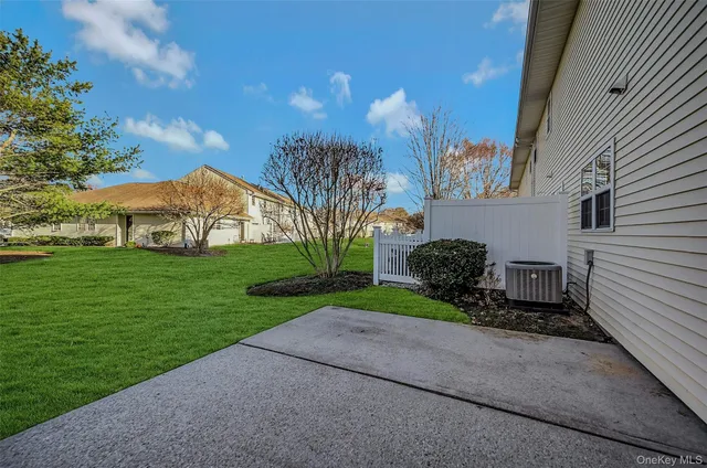 a view of a house with a yard and pathway