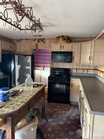 a kitchen with a stove and a wooden cabinets