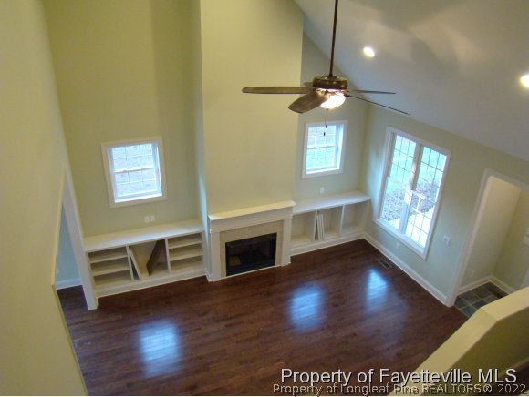 195 Thorne Road Pinehurst, NC 28374 - Photo 3 of 20 a view of a livingroom with wooden floor a ceiling fan and a window