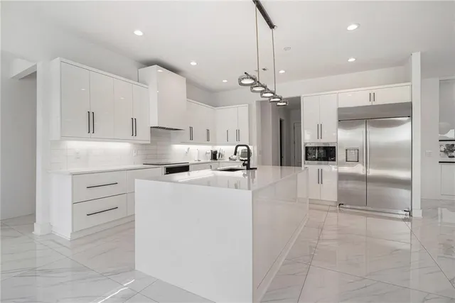 a kitchen with a table chairs stove and kitchen view