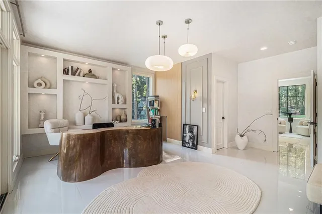 a room with furniture and large windows