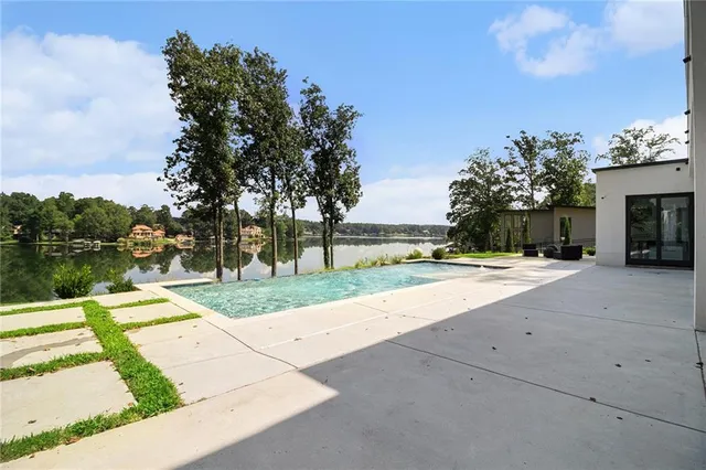 a front view of a house with a yard and trees