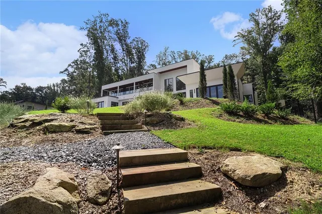 an aerial view of a house with a yard and lake view