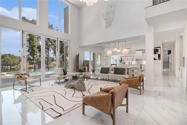 a living room with furniture and large windows