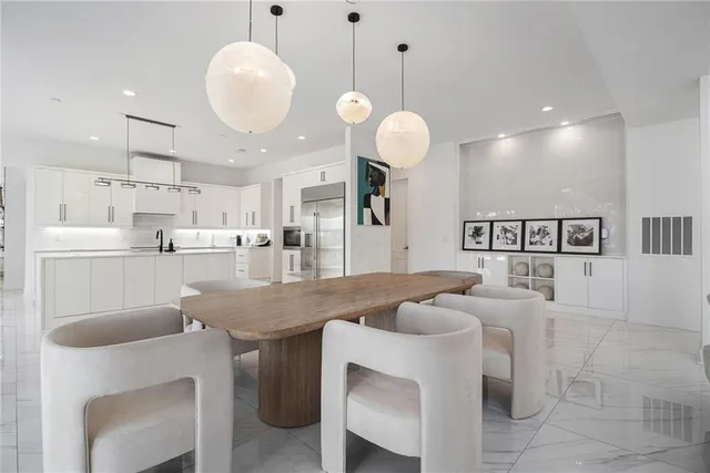 a kitchen with cabinets table and chairs