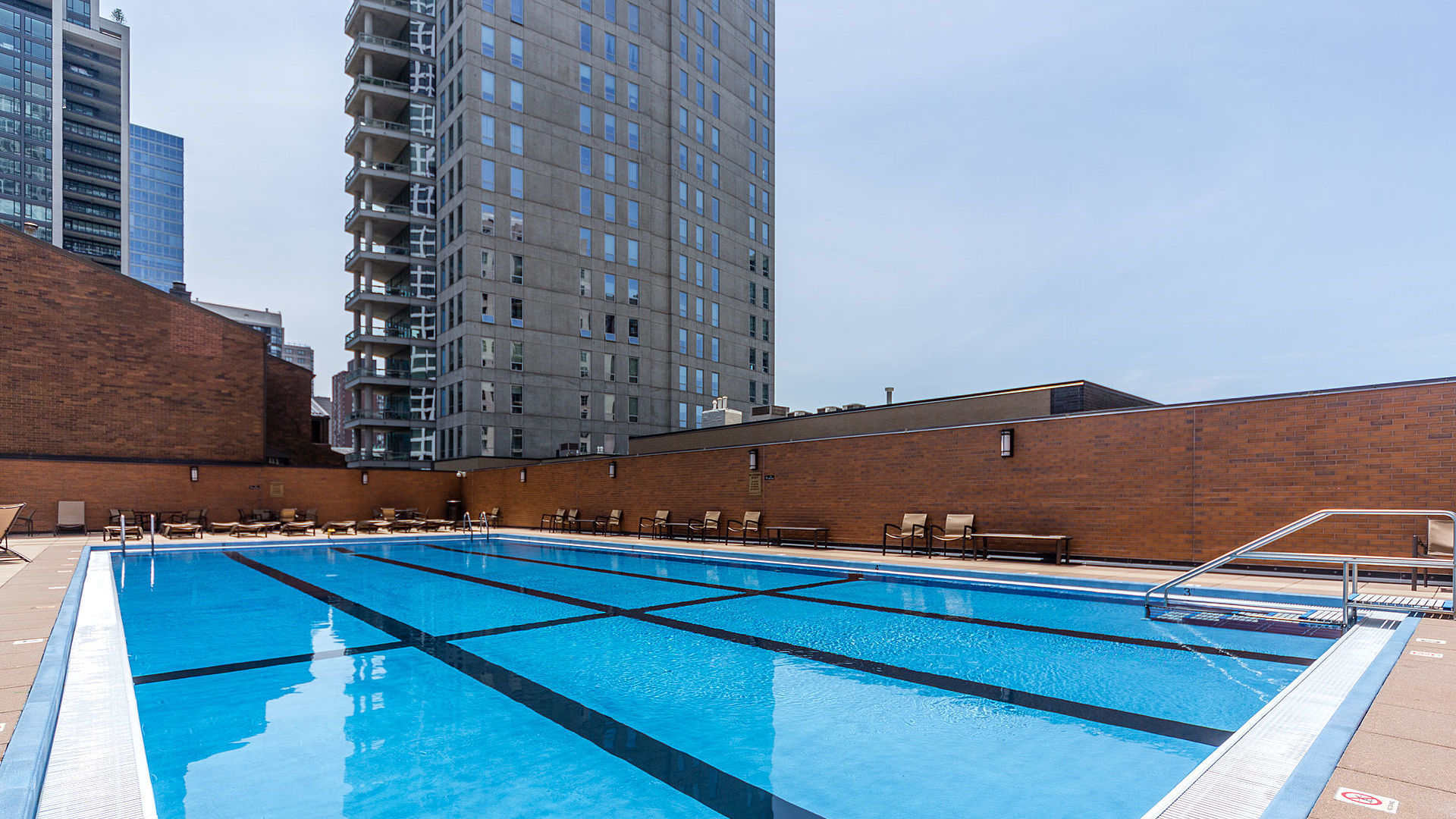 1030 North State Street, Unit 13E Chicago, IL 60610 - Photo 18 of 26 a view of a balcony with chairs and wooden floor