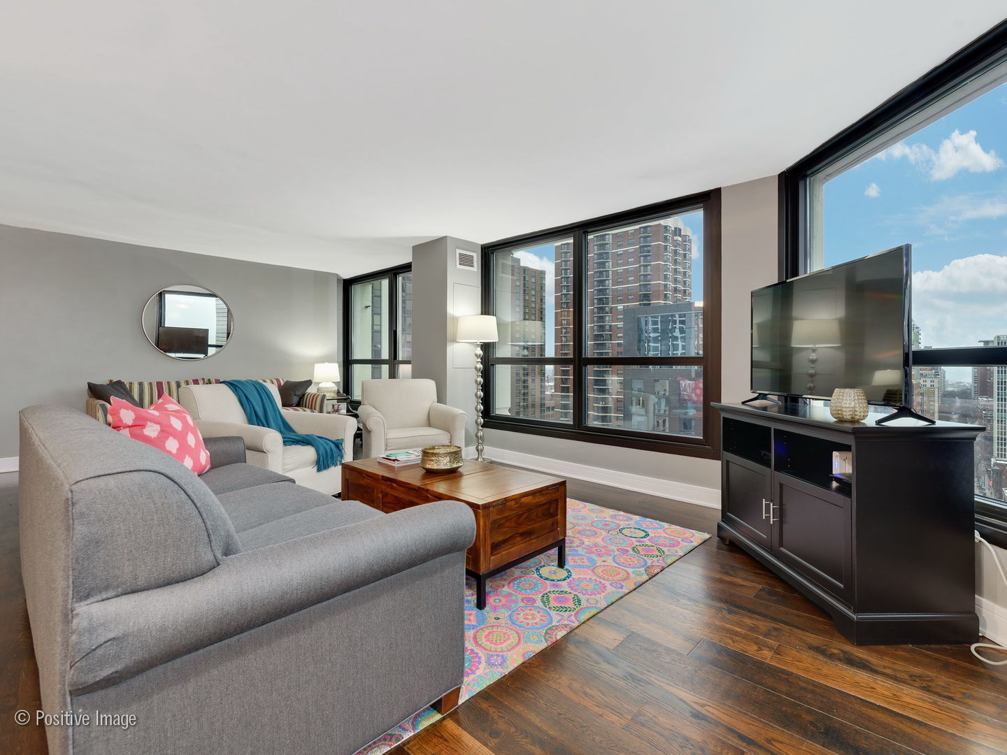 1030 North State Street, Unit 13E Chicago, IL 60610 - Photo 8 of 26 a living room with furniture and a flat screen tv