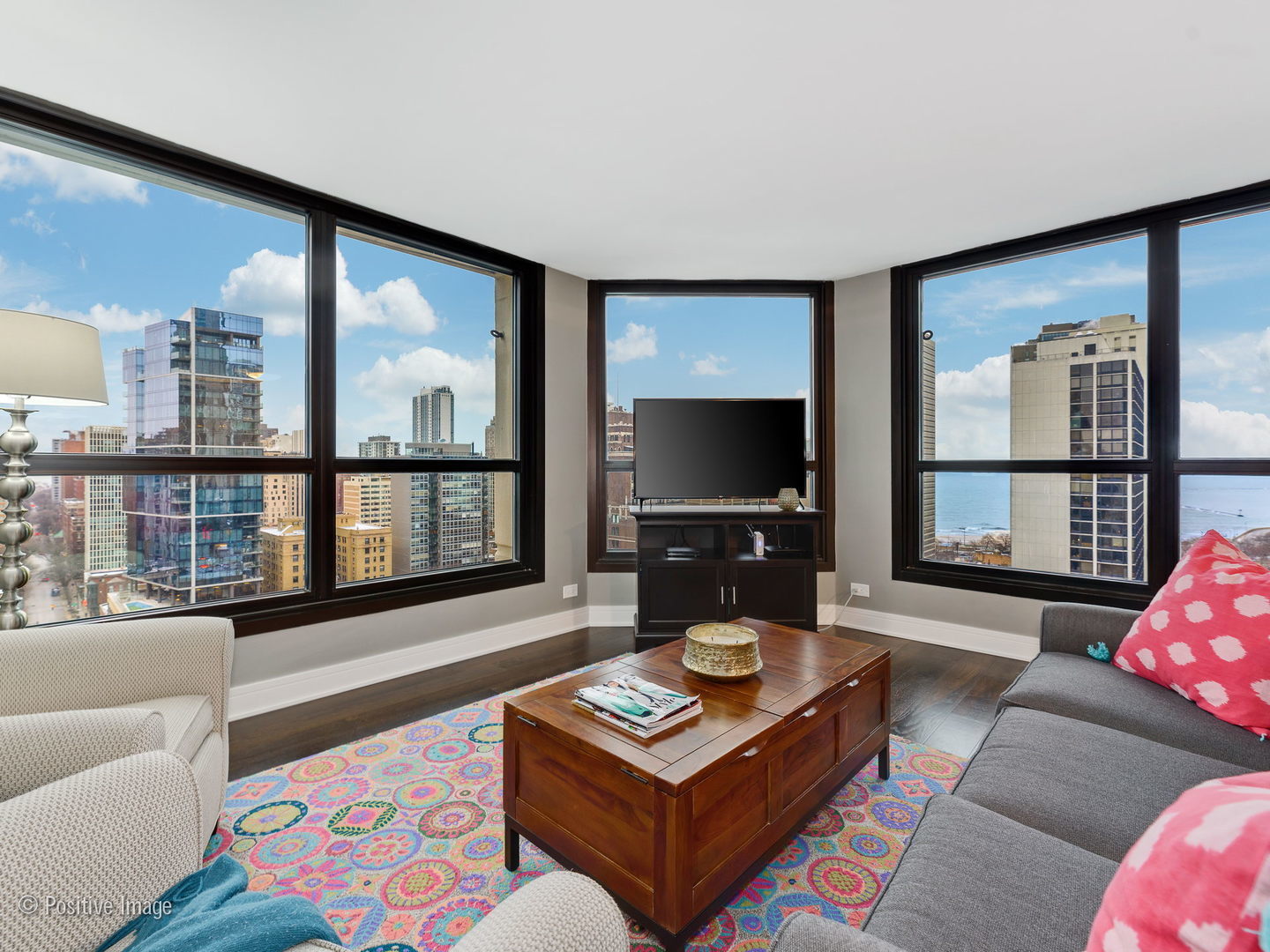 1030 North State Street, Unit 13E Chicago, IL 60610 - Photo 10 of 26 a living room with furniture and a flat screen tv