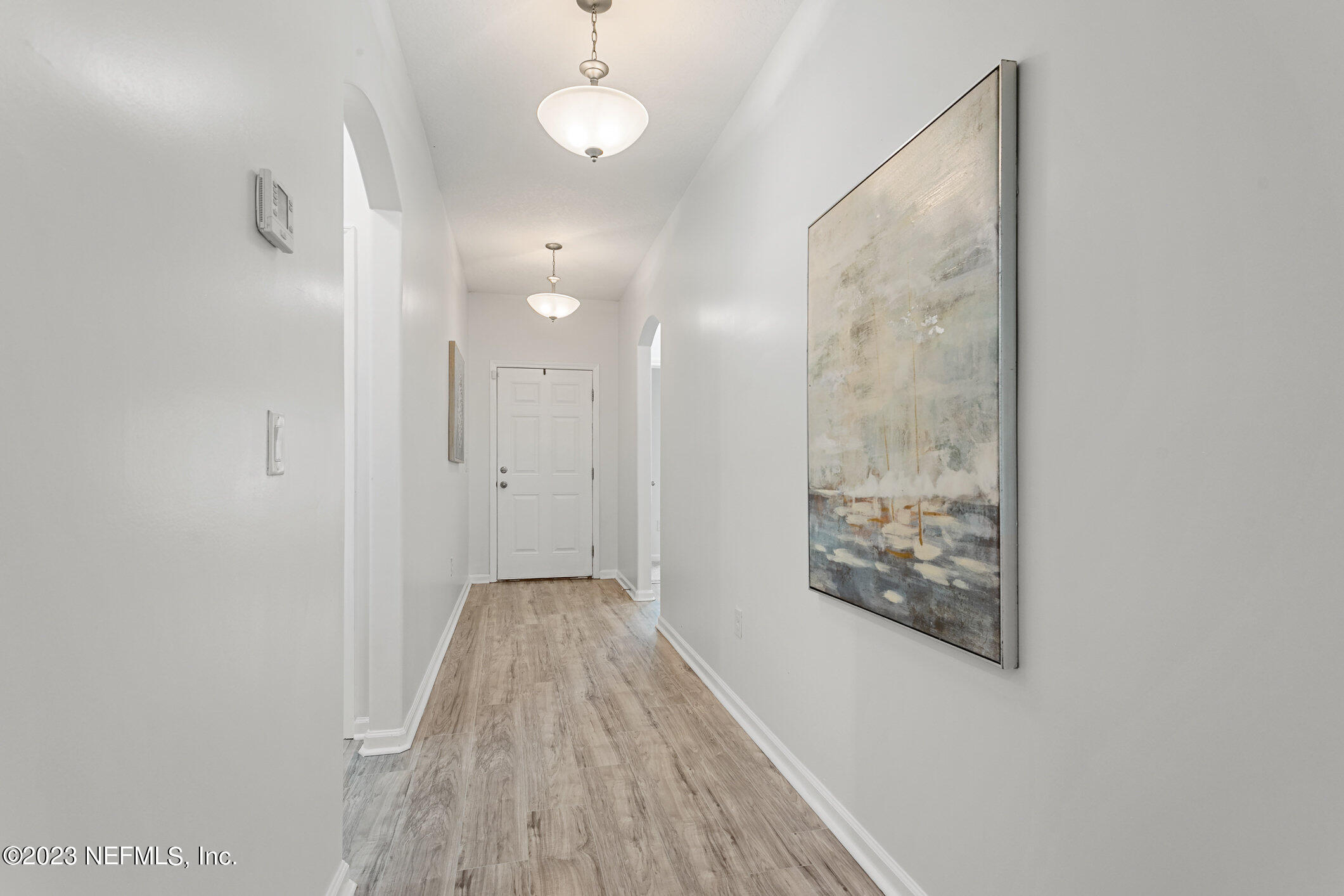 9864 Sailor Drive Jacksonville, FL 32221 - Photo 12 of 44 a view of a hallway with wooden floor and a bathroom