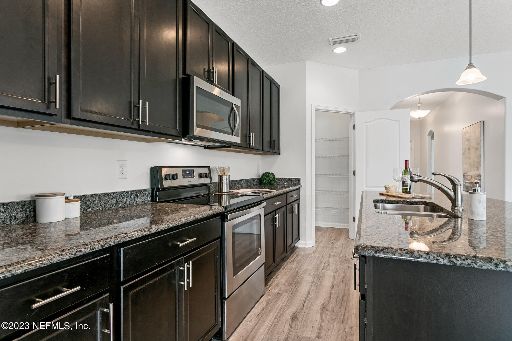 9864 Sailor Drive Jacksonville, FL 32221 - Photo 17 of 44 a kitchen with stainless steel appliances granite countertop a sink stove and refrigerator