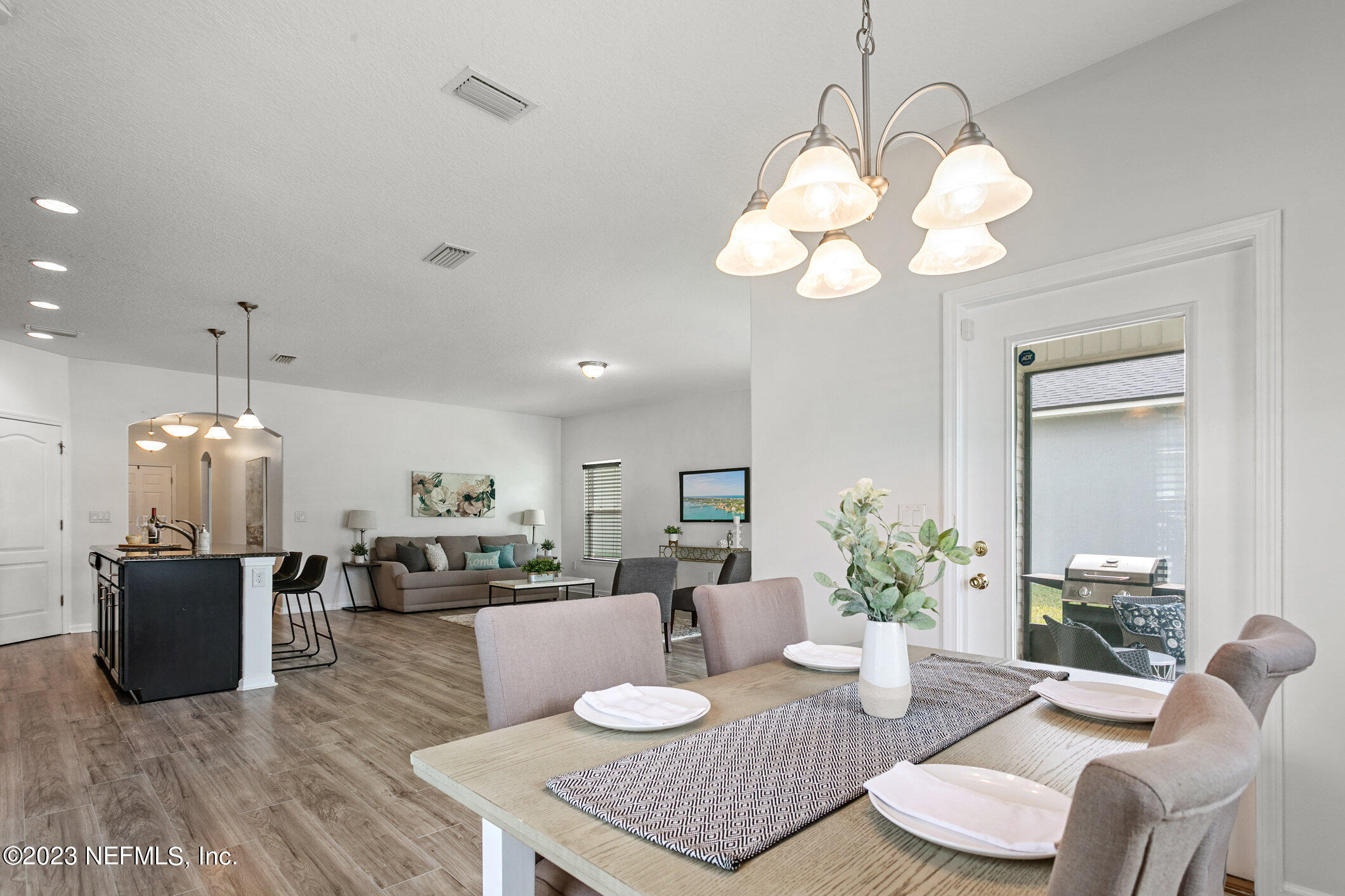 9864 Sailor Drive Jacksonville, FL 32221 - Photo 20 of 44 a living room with furniture kitchen and a chandelier