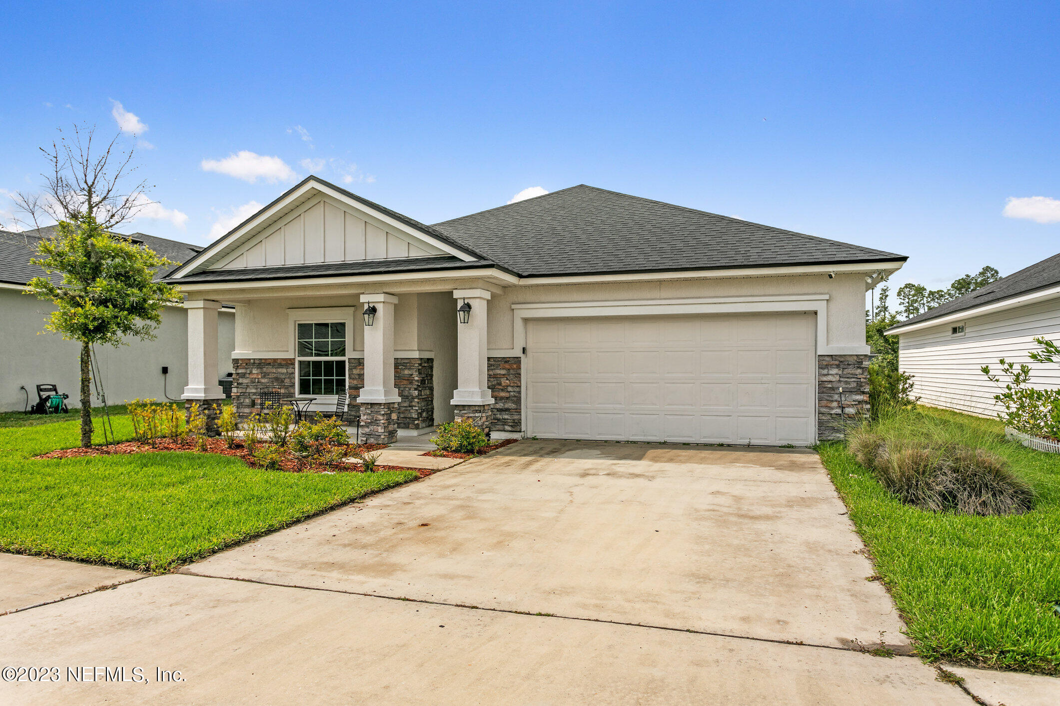 9864 Sailor Drive Jacksonville, FL 32221 - Photo 2 of 44 a front view of a house with a yard and garage