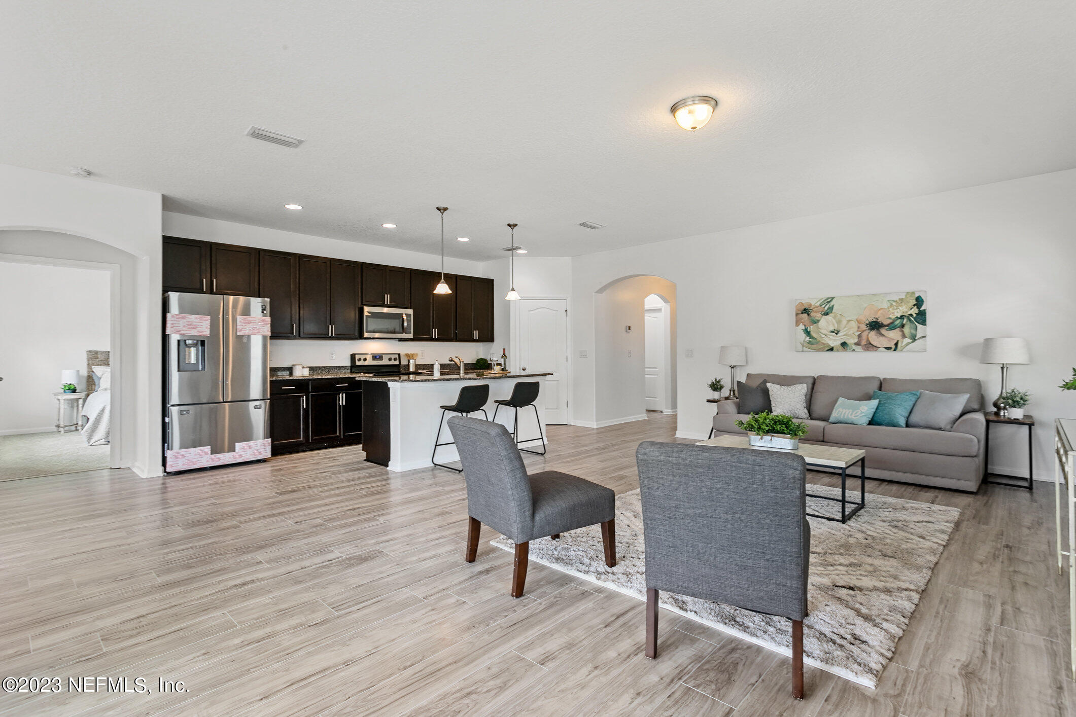9864 Sailor Drive Jacksonville, FL 32221 - Photo 21 of 44 a living room with furniture and kitchen view