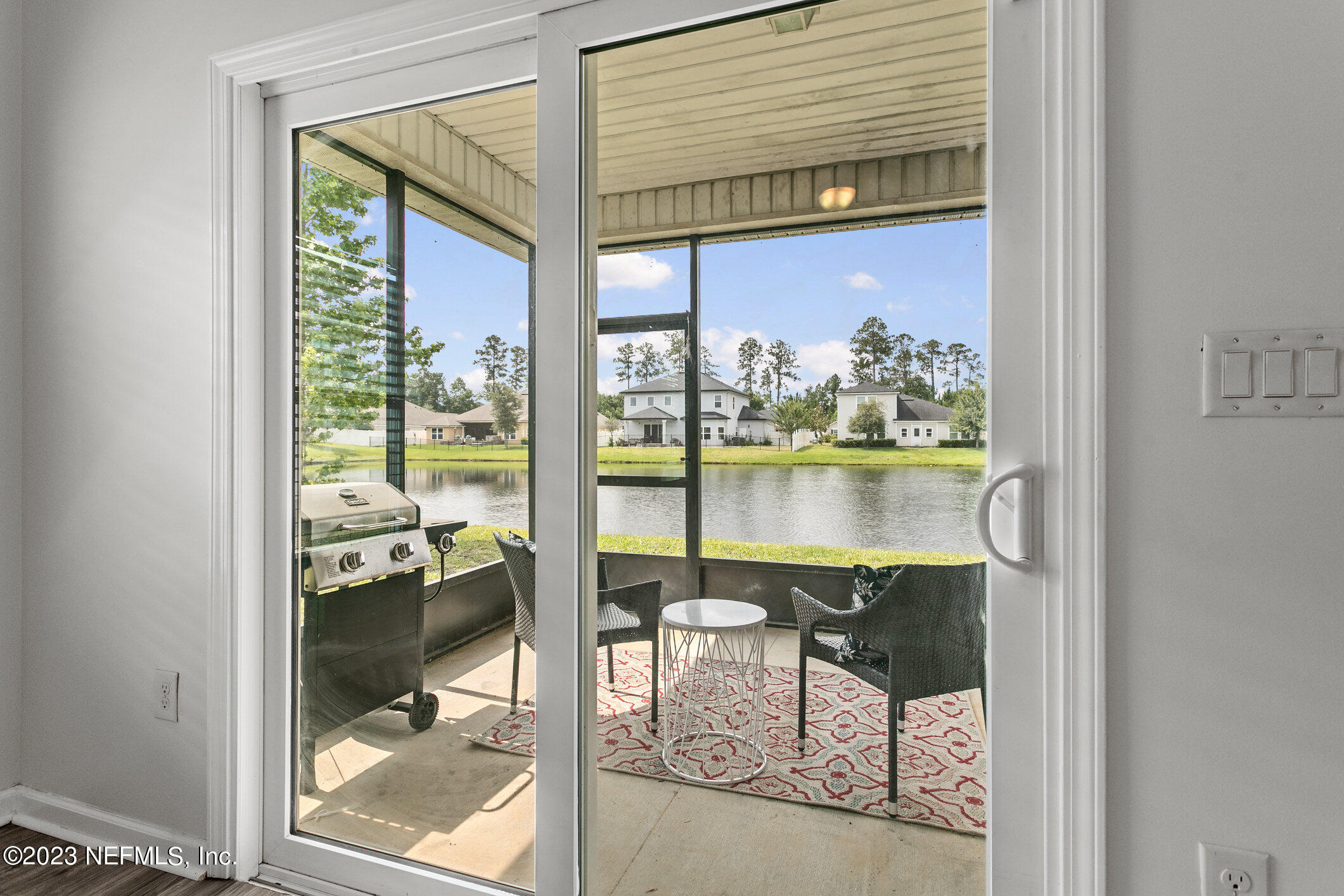 9864 Sailor Drive Jacksonville, FL 32221 - Photo 24 of 44 a dining room with furniture and a floor to ceiling window