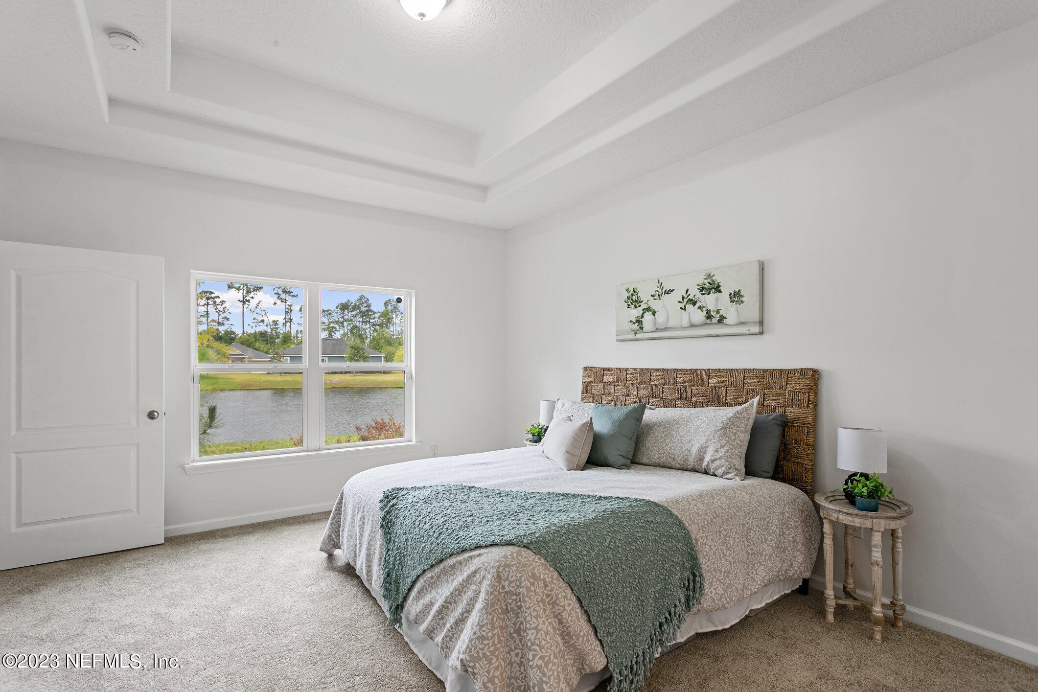 9864 Sailor Drive Jacksonville, FL 32221 - Photo 27 of 44 a bedroom with a large bed and a window