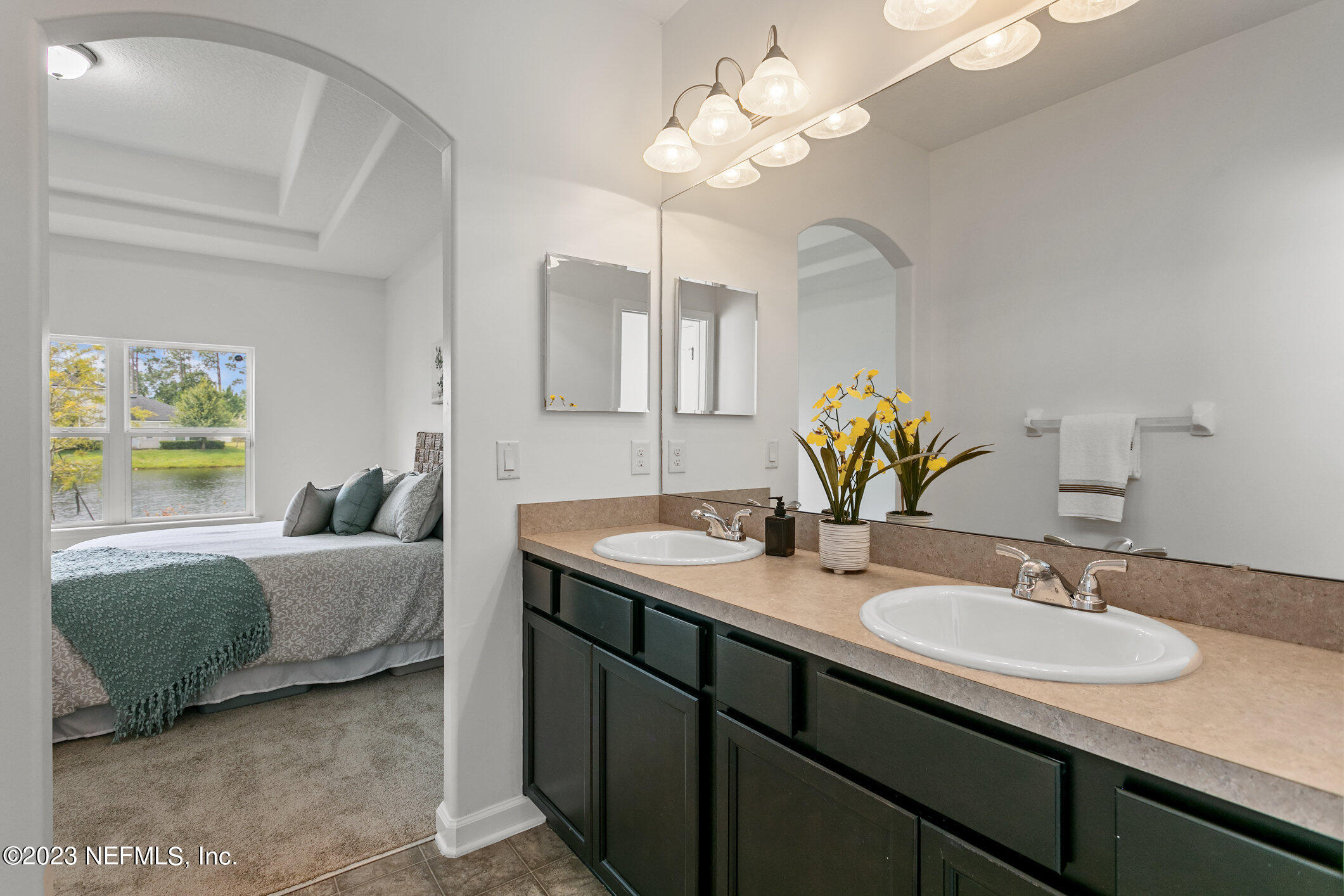 9864 Sailor Drive Jacksonville, FL 32221 - Photo 28 of 44 a en suite bathroom with a granite countertop sink and a mirror