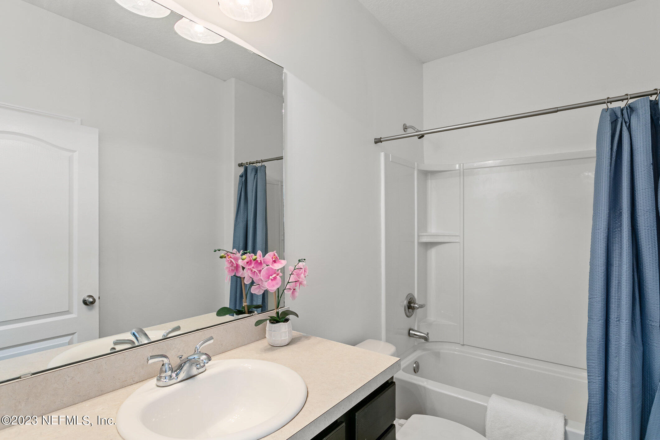9864 Sailor Drive Jacksonville, FL 32221 - Photo 32 of 44 a bathroom with a granite countertop sink mirror and a shower