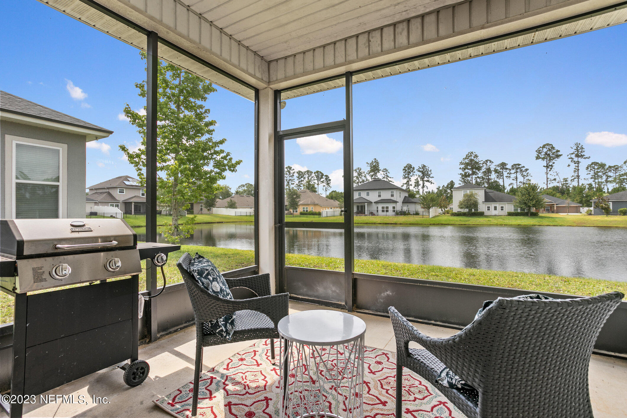 9864 Sailor Drive Jacksonville, FL 32221 - Photo 37 of 44 a dining room with furniture and a floor to ceiling window