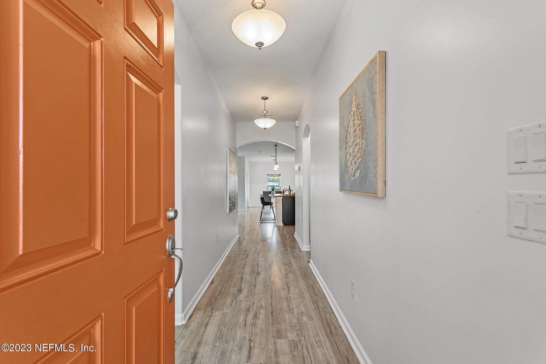9864 Sailor Drive Jacksonville, FL 32221 - Photo 7 of 44 a view of a hallway with wooden floor and staircase