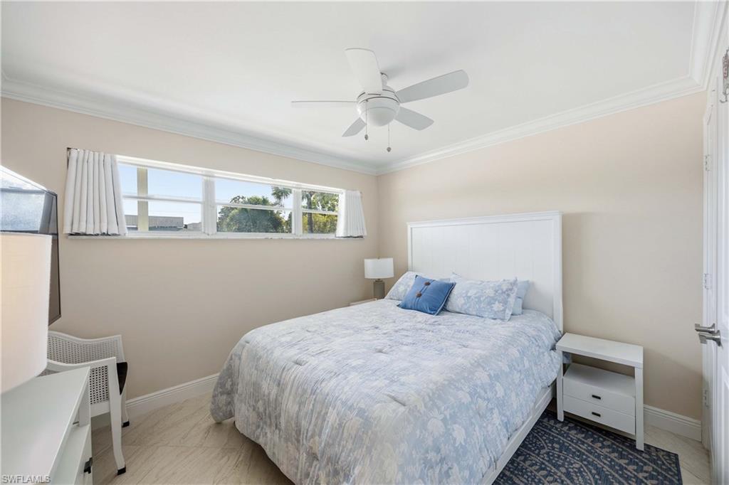 610 Broad Avenue South, Unit J610 Naples, FL 34102 - Photo 12 of 20 Bedroom featuring ornamental molding and a ceiling fan