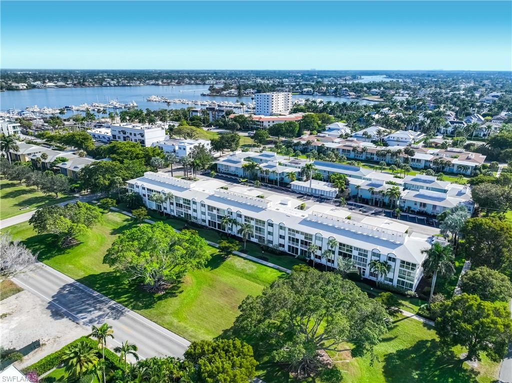 610 Broad Avenue South, Unit J610 Naples, FL 34102 - Photo 17 of 20 Bird's eye view of apartment complex and a nearby body of water