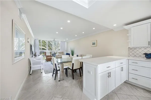a kitchen with a table chairs and a refrigerator