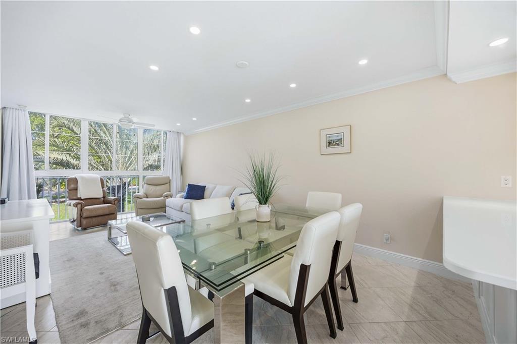 610 Broad Avenue South, Unit J610 Naples, FL 34102 - Photo 8 of 20 Dining area with floor to ceiling windows, recessed lighting, crown molding, and a ceiling fan