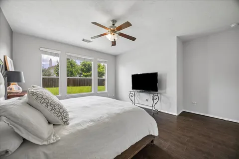 a bedroom with a bed and a flat screen tv