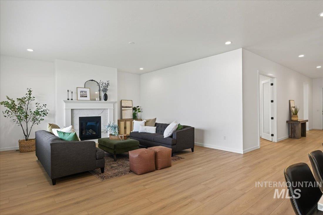 14675 Serenity Pt Street Caldwell, ID 83607 - Photo 2 of 14 Living room featuring a tile fireplace, light wood-type flooring, and recessed lighting
