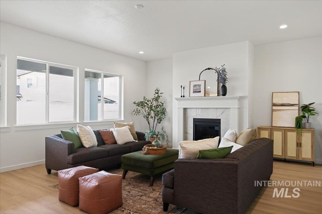 14675 Serenity Pt Street Caldwell, ID 83607 - Photo 3 of 14 Living room featuring light wood-type flooring, a fireplace, and recessed lighting