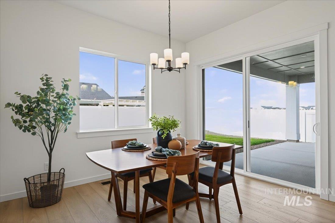 14675 Serenity Pt Street Caldwell, ID 83607 - Photo 8 of 14 Dining area featuring light wood-style flooring and a chandelier
