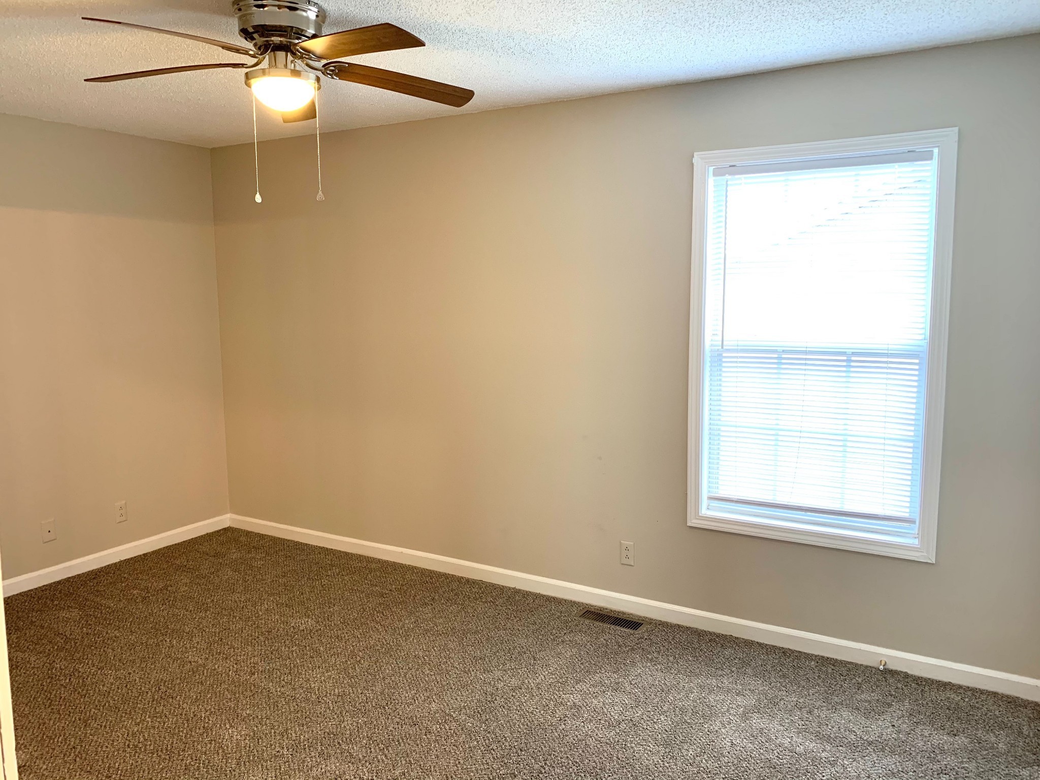 200 Tree Line Drive Oak Grove, KY 42262 - Photo 49 of 58 an empty room with a window and chandelier fan
