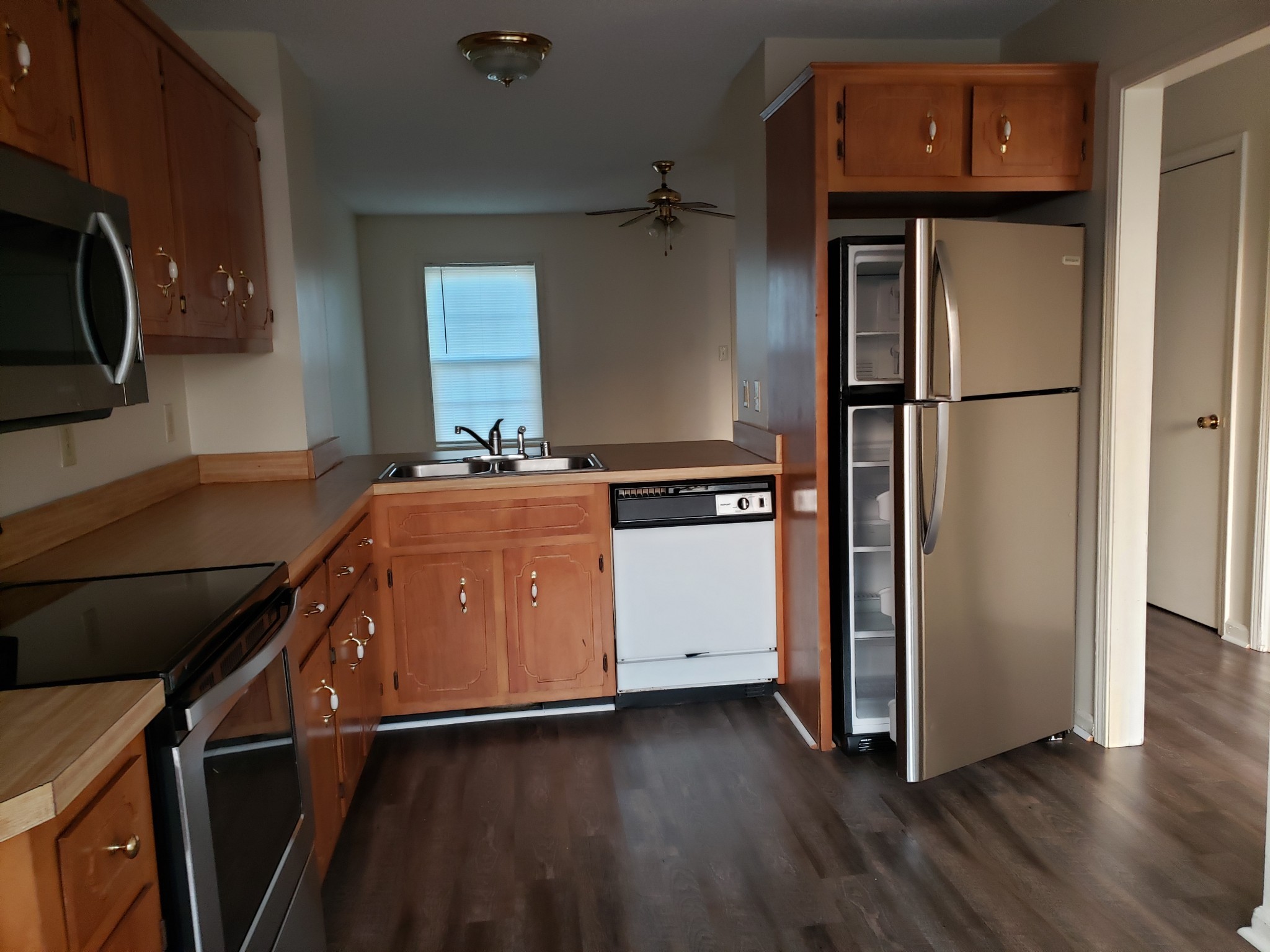 200 Tree Line Drive Oak Grove, KY 42262 - Photo 6 of 58 a kitchen with a refrigerator stove and wooden cabinets
