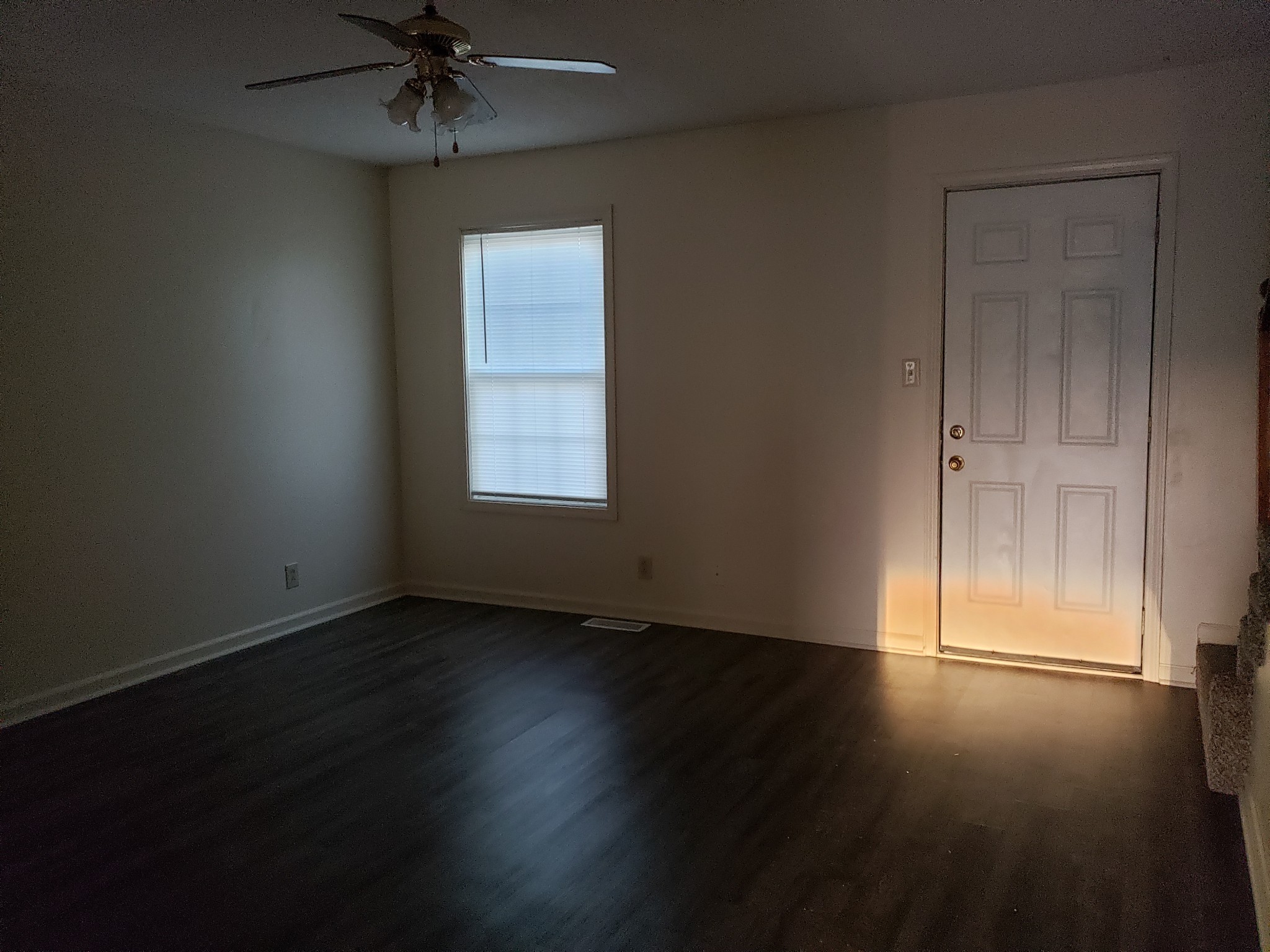 200 Tree Line Drive Oak Grove, KY 42262 - Photo 9 of 58 an empty room with wooden floor fan and windows
