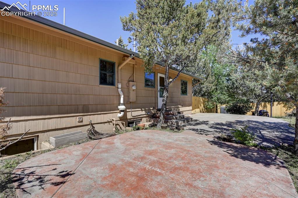 4665 Fox Road Cascade, CO 80809 - Photo 22 of 50 a view of a blue house with yard and sitting area