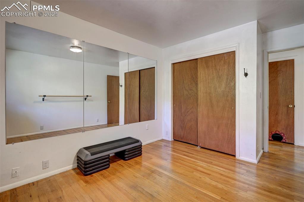 4665 Fox Road Cascade, CO 80809 - Photo 36 of 50 a room with gym equipment and wooden floor