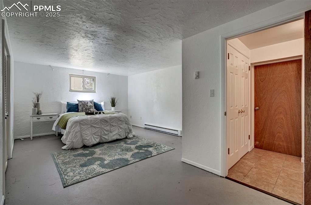 4665 Fox Road Cascade, CO 80809 - Photo 41 of 50 a bedroom with a large bed and a couch